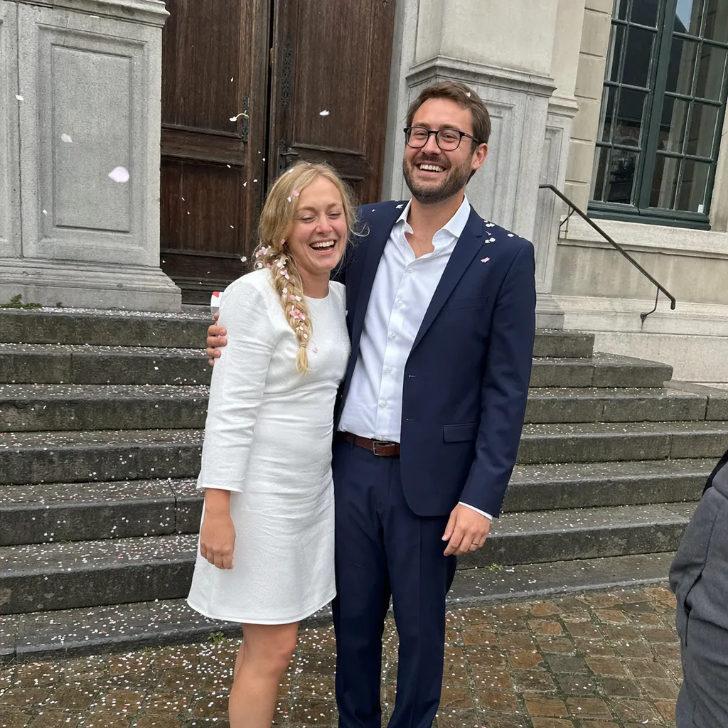 Phone photo: Elise and Tom laughing on the town hall steps after the ceremony